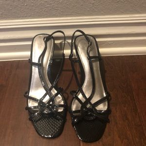 Black patten leather kitten heels.